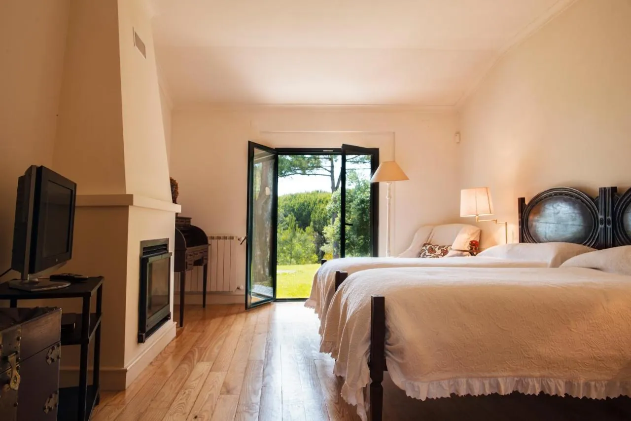 Bedroom with fireplace and doors to the garden
